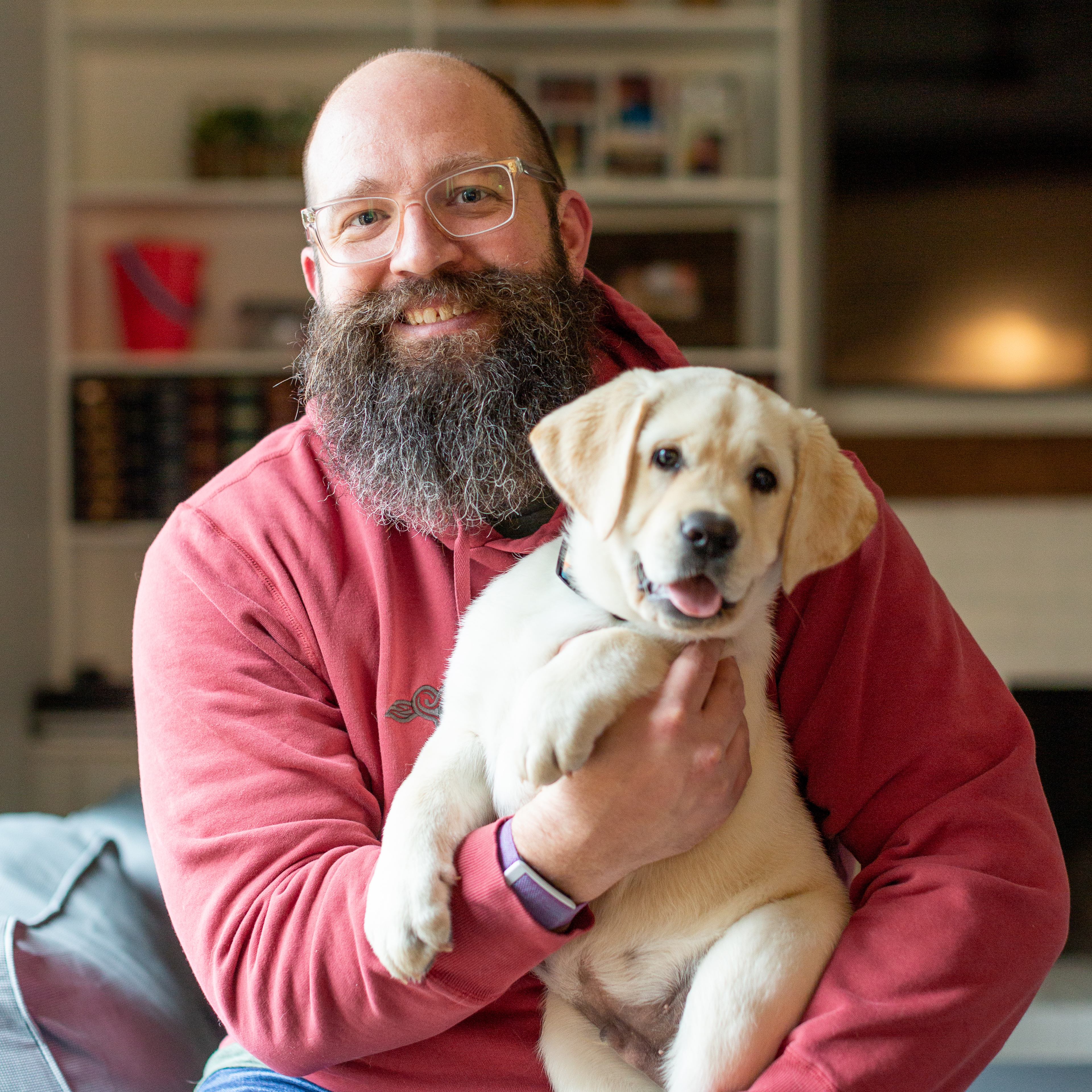 Ray Ellen holding Barley, a yellow Labrador puppy